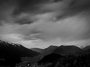 Scenic view of mountains against cloudy sky