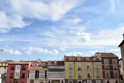 Low angle view of building against cloudy sky