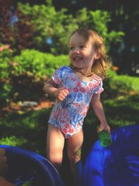 Portrait of cute girl playing in kiddie pool