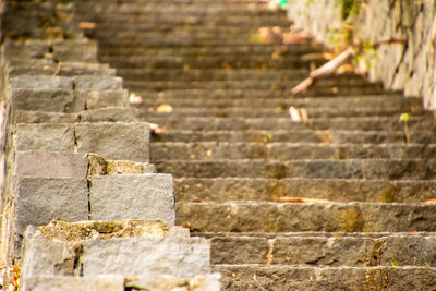 Low section of person on stone wall