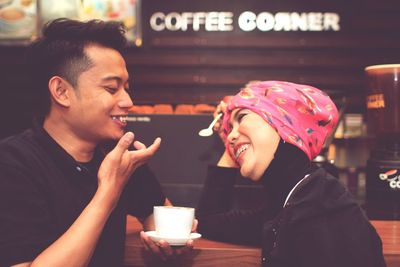 Cheerful couple on date in cafe