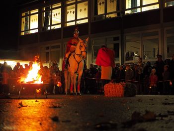 Group of people in front of fire at night