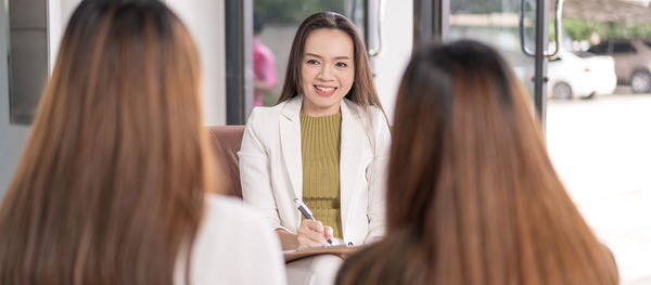 Young woman with text on table