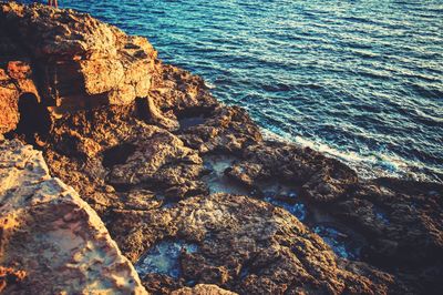 High angle view of rocky shore during sunset