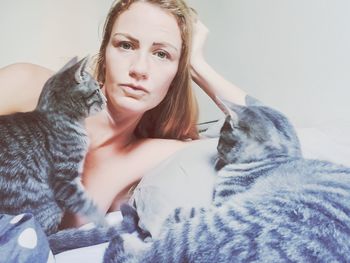 Portrait of beautiful young woman with cats