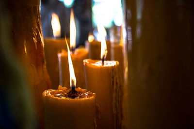 Close-up of lit candles in temple