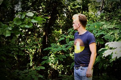 Full length of young man looking at forest