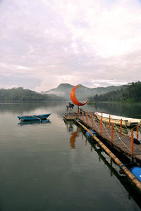 The photographer is aiming for a picture of a boat on a lake. sermo reservoir, kulonprogo