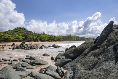 Rocks on beach against sky