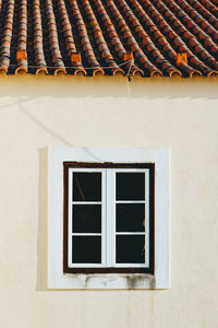 Low angle view of window on wall of building