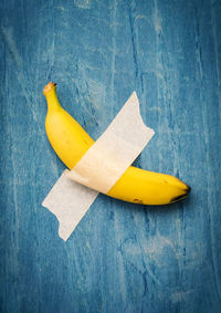 High angle view of yellow banana on blue table