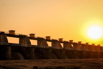 Scenic view of dam against sky during sunset