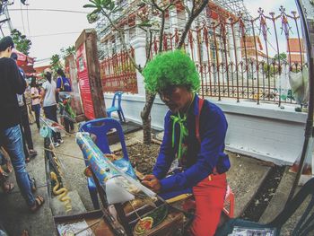 Young man looking at fish in market