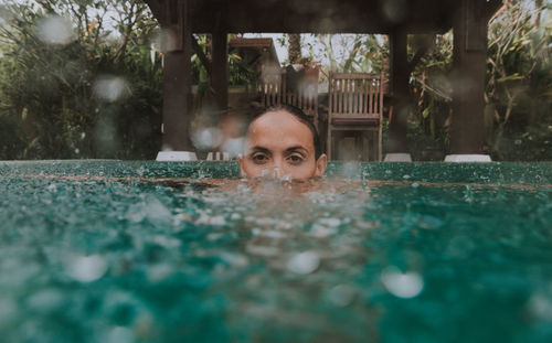 Portrait of man swimming in pool