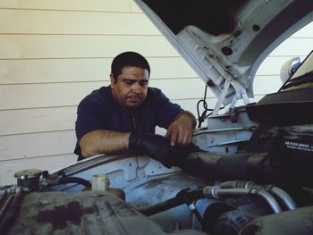 Mechanic repairing car engine