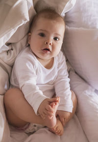 Portrait of cute baby boy sleeping on bed at home