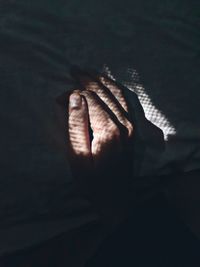 High angle view of person hand in the dark