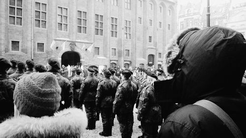 Rear view of army men in front of building