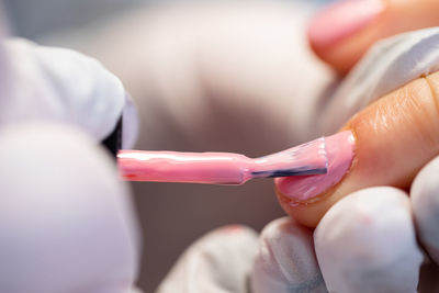 Midsection of doctor holding dentures