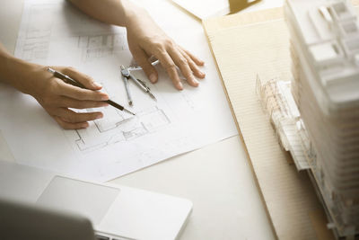 High angle view of hands working on table
