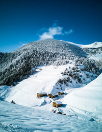 Snow covered mountain against blue sky