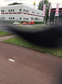 Cars on road by buildings in city