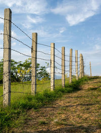 Fence on field against sky