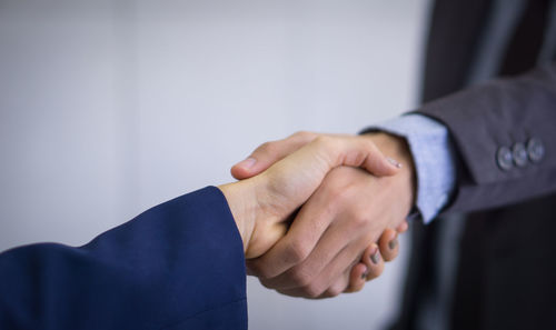 Cropped image of man holding hands