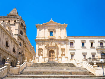 Low angle view of historical building against clear blue sky