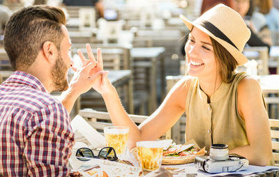 Romantic tourist couple spending leisure time at outdoor restaurant