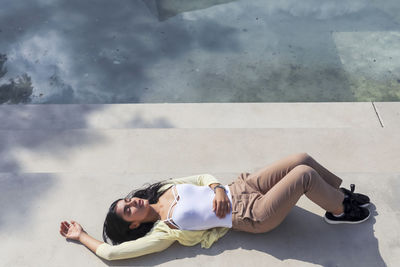 High angle view of woman lying on floor