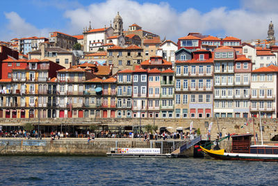 Boats in canal against buildings in city