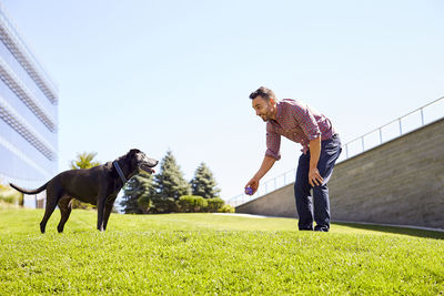 A man playing with his dog.