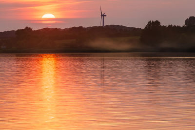 Scenic view of lake against sky during sunset