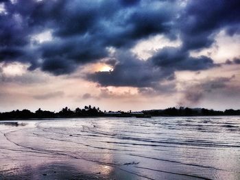 Scenic view of lake against sky at sunset