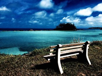 View of empty beach against cloudy sky