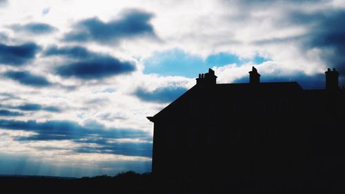 Low angle view of built structure against cloudy sky