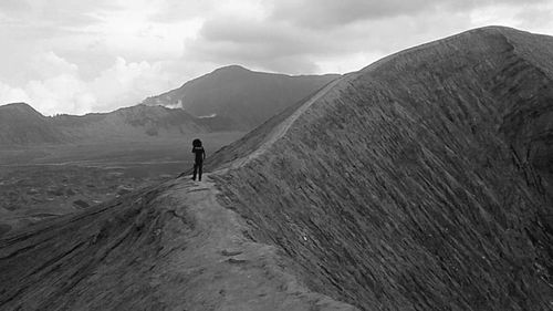 Full length of man walking on mountain against sky