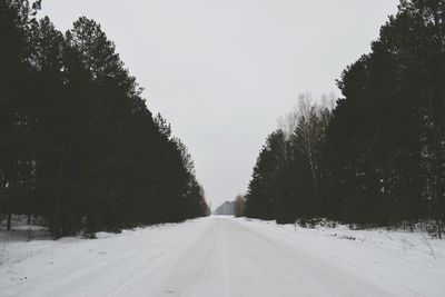 Snow covered landscape against sky