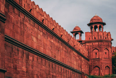 Low angle view of red building against sky