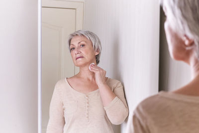 Portrait of woman standing at home