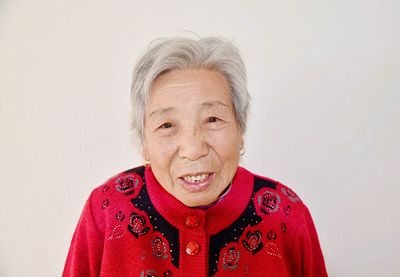 Portrait of smiling man against white background