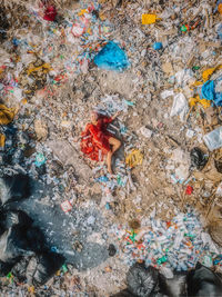 Directly above shot of woman lying down amidst garbage