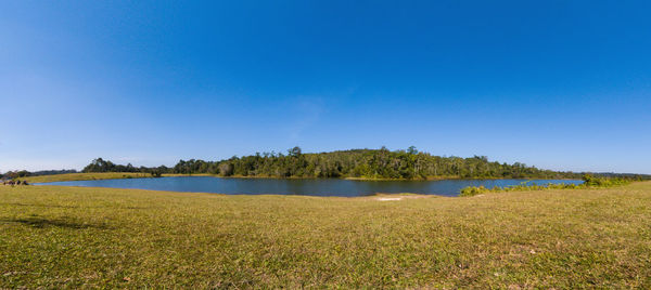 Scenic view of lake against clear blue sky