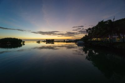 Scenic view of lake against sky at sunset