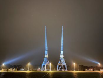 Illuminated tower against sky at night