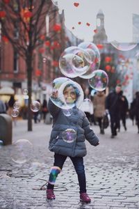Full length portrait of smiling boy on street