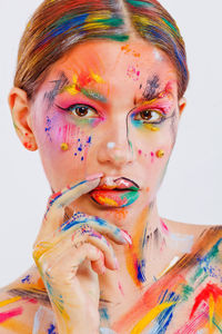 Portrait of young woman with multi colored background