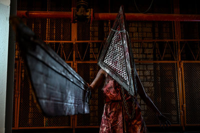 Portrait of woman with umbrella standing at night