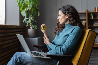 Hand and wrist exercises for office workers. female employee using carpal expander to relieve stress